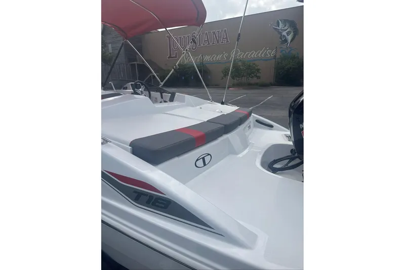 Slide: The Image of 2026 Tahoe T18 boat with red canopy, parked near a "Louisiana Fisherman's Paradise" sign. - 9