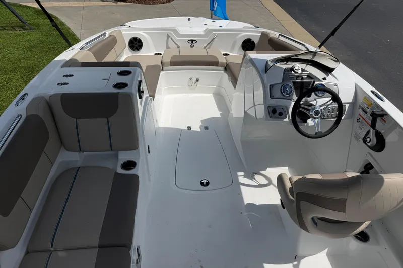 Slide: The Image of 2026 Tahoe 1950 boat interior with modern seating and steering console. - 19