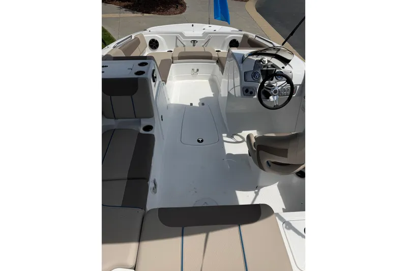 Slide: The Image of 2026 Tahoe 1950 boat interior with beige seating and modern steering console. - 18