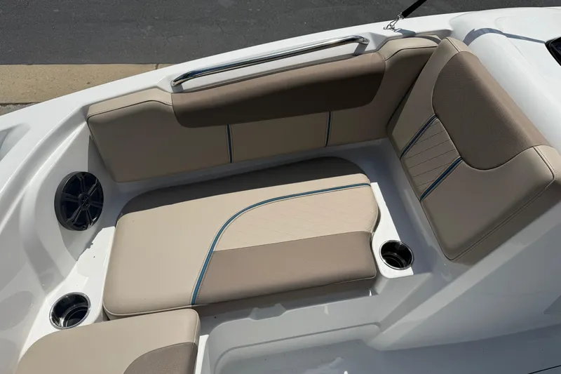 Slide: The Image of Luxurious seating area in a 2026 Tahoe 1950 boat, featuring beige upholstery and cup holders. - 12