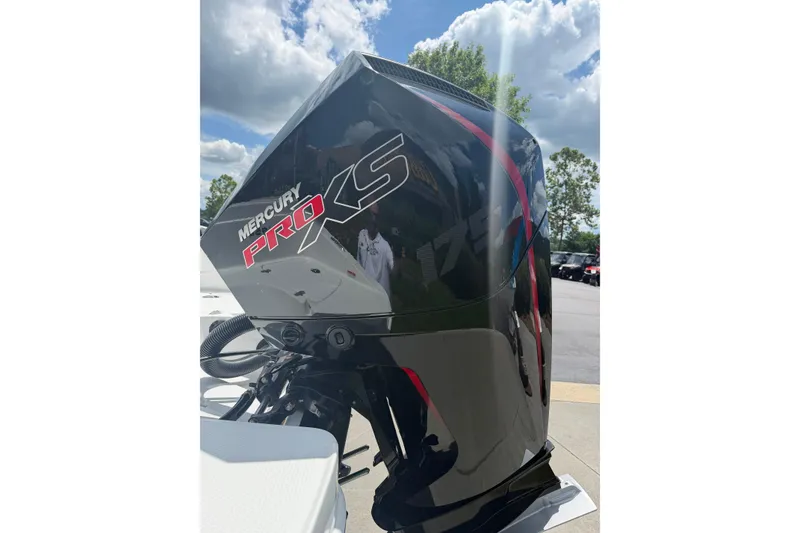 Slide: The Image of Mercury Pro XS outboard motor on Tahoe 1950, 2026 model, under a sunny sky. - 14