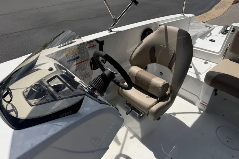 Slide: The Image of Interior of a 2026 Tahoe 1950 boat featuring a steering wheel and comfortable seating. - 21