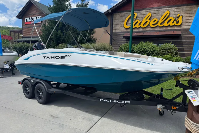 The Image of 2026 Tahoe 1950 boat on trailer outside Cabela's store. - 0