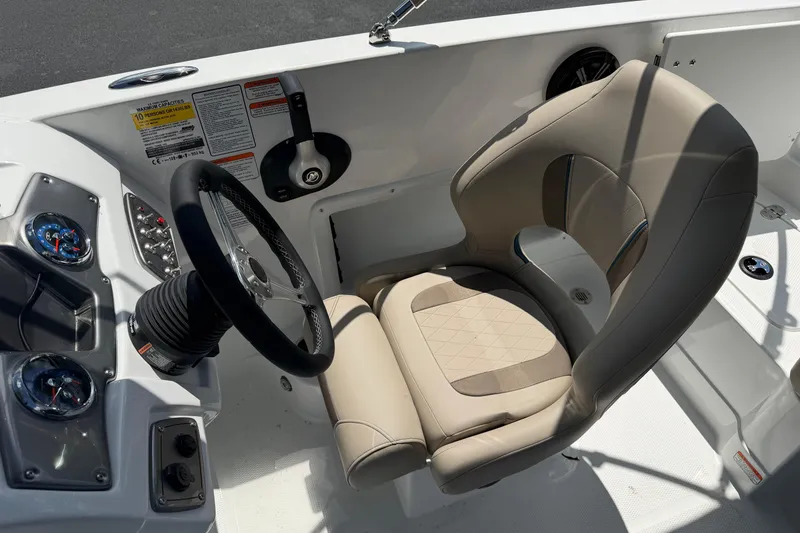Slide: The Image of Steering console of 2026 Tahoe 1950 boat with beige captain's chair and gauges. - 11