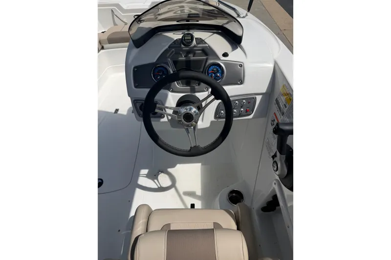 Slide: The Image of Cockpit view of 2026 Tahoe 1950 boat with steering wheel and dashboard controls. - 20