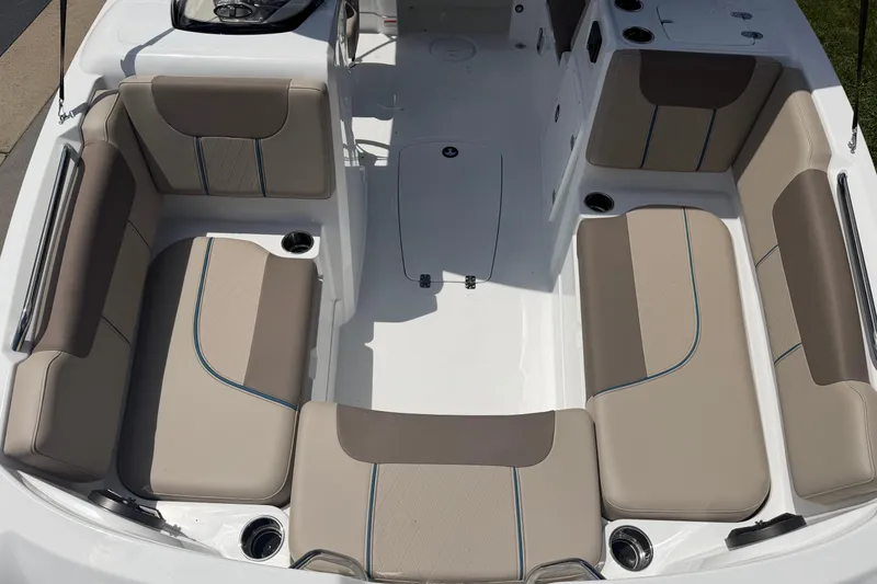Slide: The Image of Spacious seating area of 2026 Tahoe 1950 boat with beige upholstery and cup holders. - 6