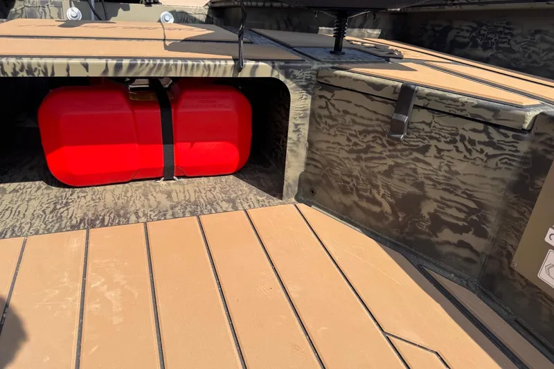 Slide: The Image of 2026 Tracker Grizzly 1756 T Marsh boat interior with red fuel tank secured under seat. - 9