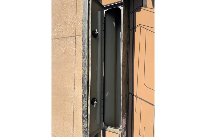 Slide: The Image of 2026 Tracker Grizzly 1756 T Marsh boat storage compartment, open view, showing interior details. - 7