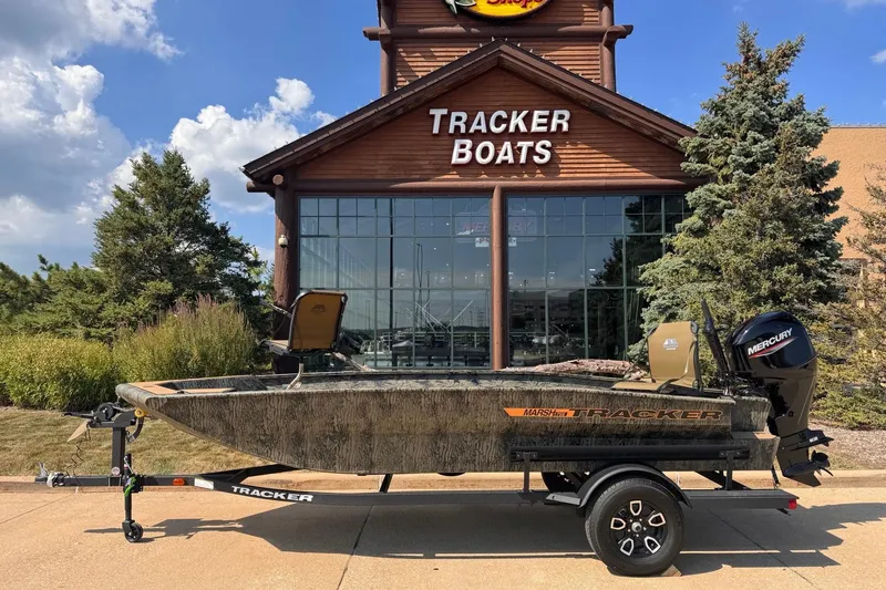 The Image of 2026 Tracker Grizzly 1756 T Marsh boat displayed outside Tracker Boats store. - 0