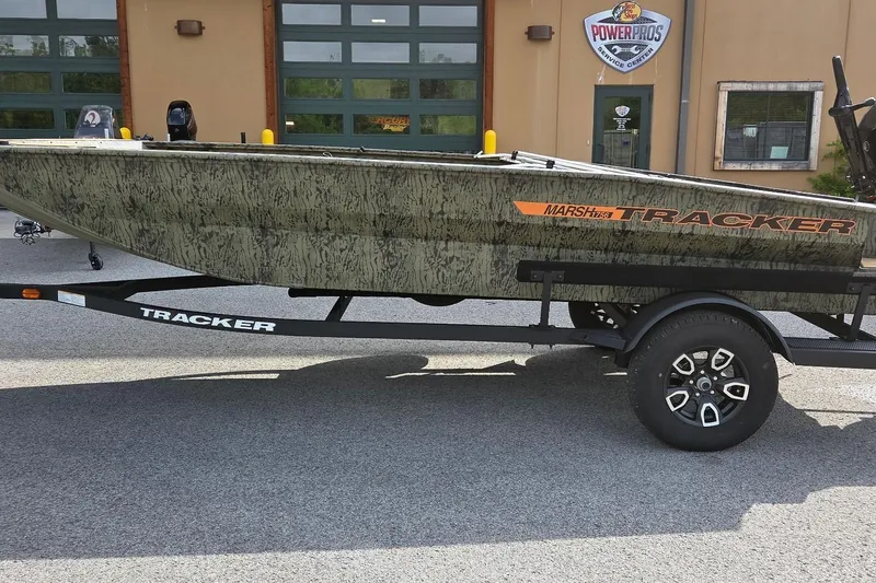 The Image of 2026 Tracker Grizzly 1756 T Marsh boat on trailer outside service center. - 0