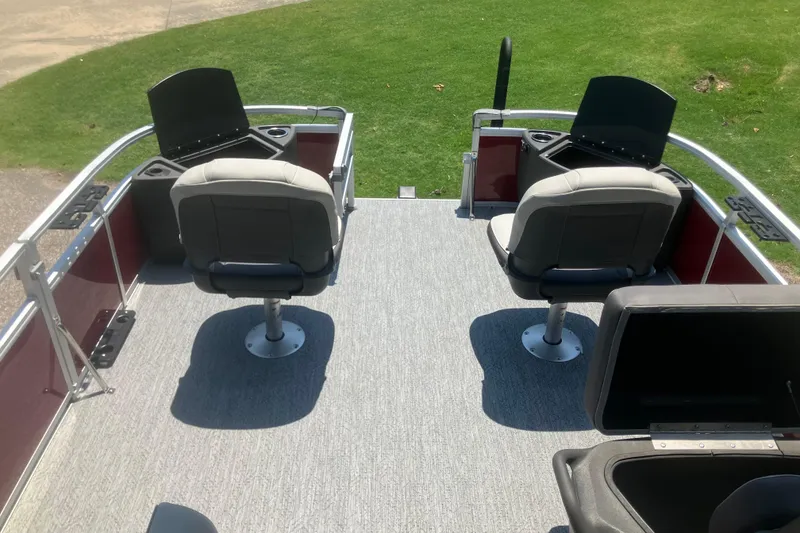 Slide: The Image of 2026 Sun Tracker Bass Buggy 18 DLX pontoon boat interior with seating and storage compartments. - 6