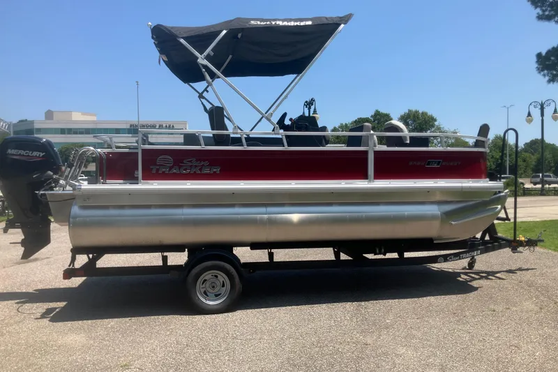 Slide: The Image of 2026 Sun Tracker Bass Buggy 18 DLX pontoon boat with canopy on trailer. - 5