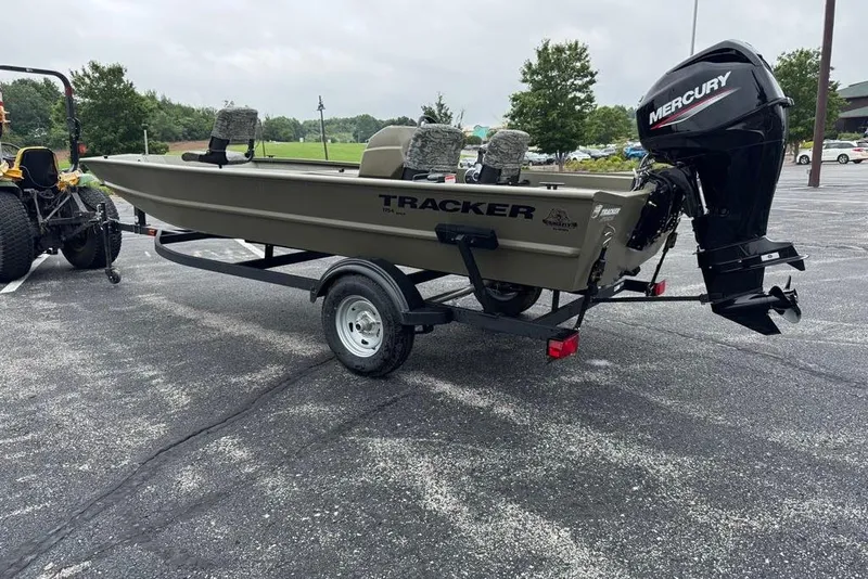 Slide: The Image of 2026 Tracker Grizzly 1754 SC boat on trailer with Mercury outboard motor in parking lot. - 5