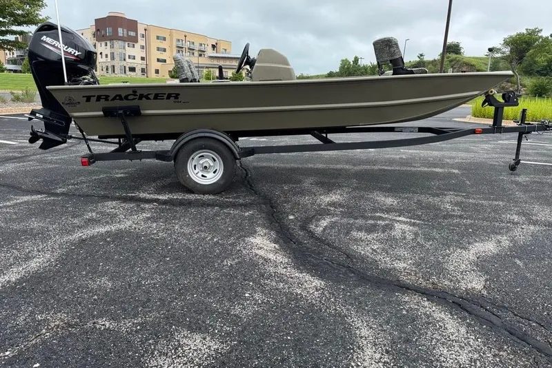 Slide: The Image of 2026 Tracker Grizzly 1754 SC boat on trailer, parked in a lot. - 2