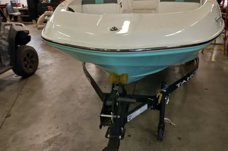 Slide: The Image of 2026 Tahoe T16 boat on trailer in a garage setting. - 3