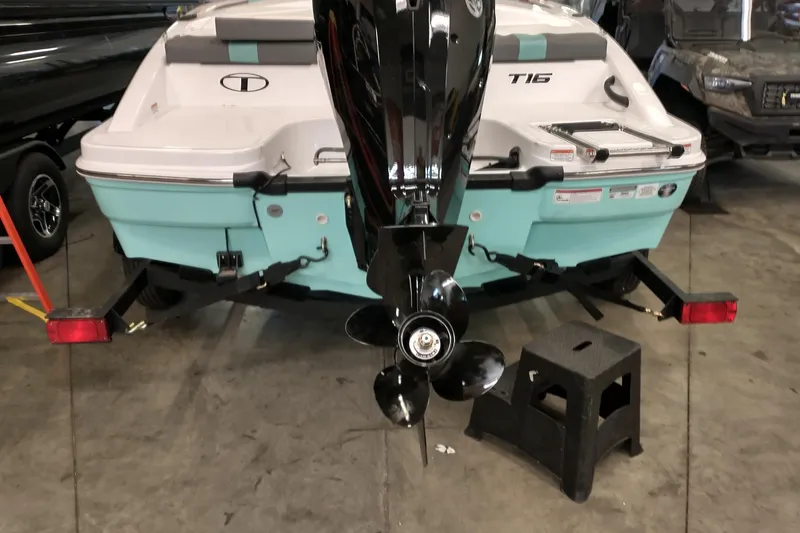 Slide: The Image of Rear view of 2026 Tahoe T16 boat with outboard motor in a garage. - 4