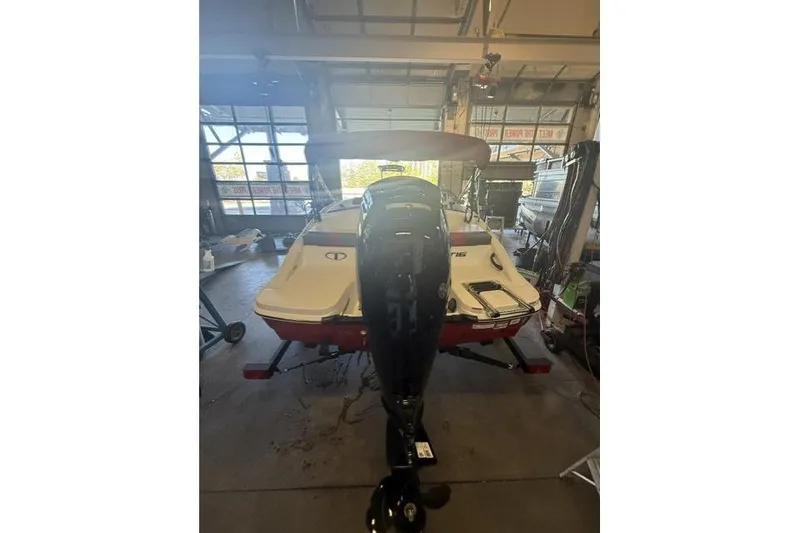 Slide: The Image of 2026 Tahoe T16 boat in a garage, featuring a powerful outboard motor. - 5