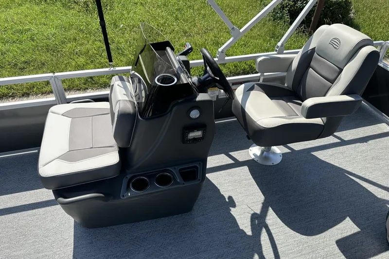 Slide: The Image of 2026 Sun Tracker Bass Buggy 18 DLX interior with steering console and seating. - 18