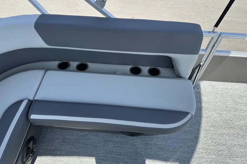 Slide: The Image of 2026 Sun Tracker Bass Buggy 18 DLX boat seating with cup holders and gray upholstery. - 21
