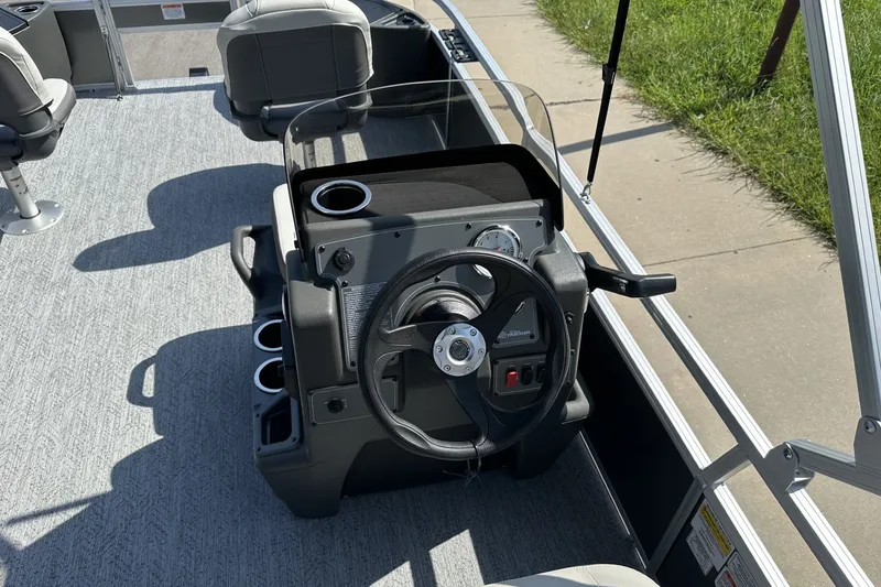 Slide: The Image of 2026 Sun Tracker Bass Buggy 18 DLX boat interior with steering console and seating. - 19