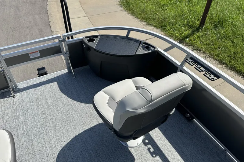 Slide: The Image of 2026 Sun Tracker Bass Buggy 18 DLX pontoon boat interior with seating and railing. - 16