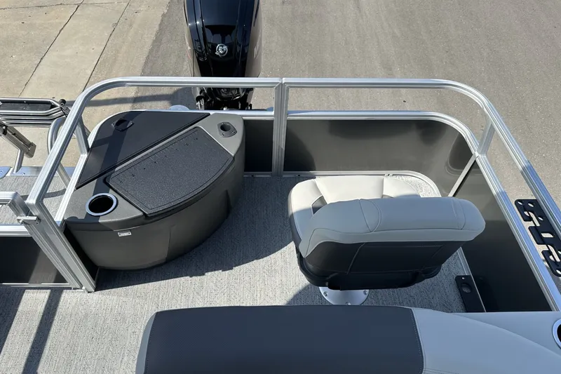 Slide: The Image of 2026 Sun Tracker Bass Buggy 18 DLX boat interior with seating and console. - 26