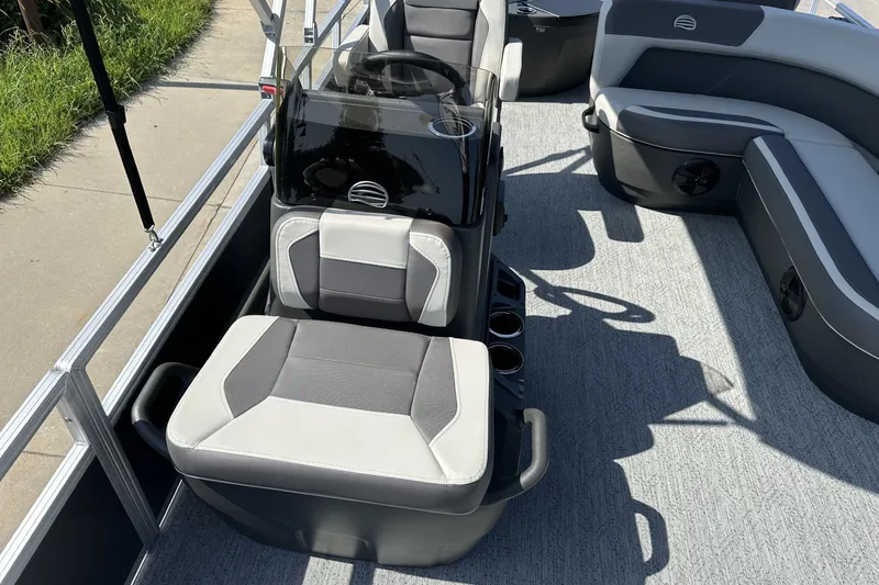 Slide: The Image of 2026 Sun Tracker Bass Buggy 18 DLX interior with gray seating and steering console. - 17