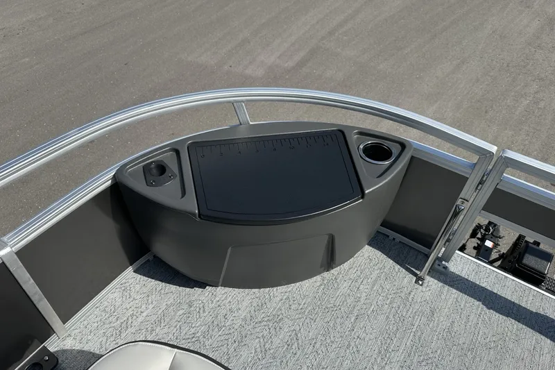 Slide: The Image of 2026 Sun Tracker Bass Buggy 18 DLX pontoon boat deck with storage and cup holder. - 13