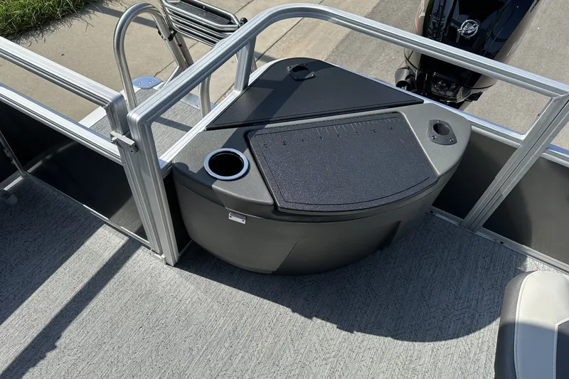Slide: The Image of 2026 Sun Tracker Bass Buggy 18 DLX pontoon boat interior with storage and cup holder. - 25