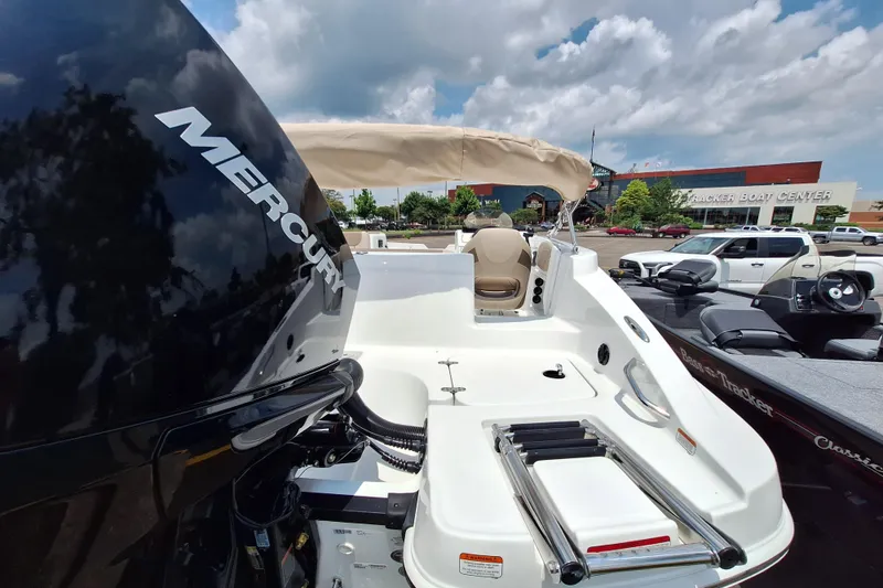 Slide: The Image of 2026 Tahoe 2150 boat with Mercury engine at Tracker Boat Center under cloudy sky. - 6