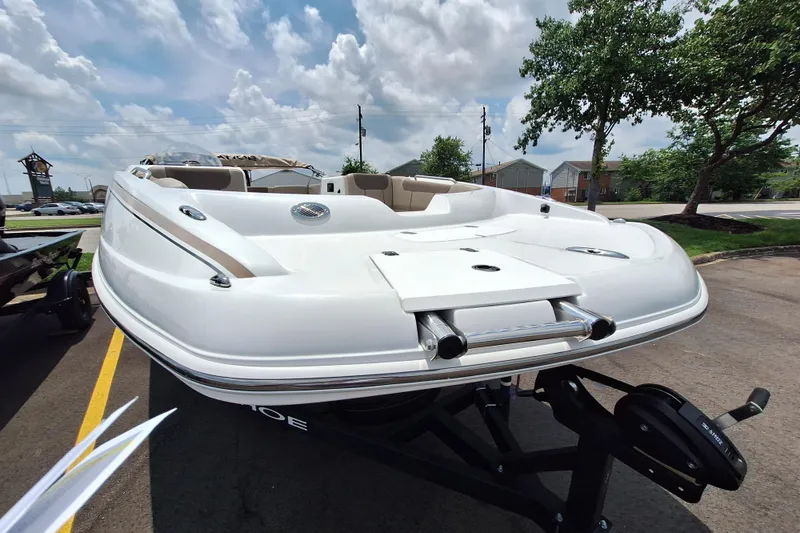 Slide: The Image of 2026 Tahoe 2150 boat on trailer, parked outdoors under a cloudy sky. - 3