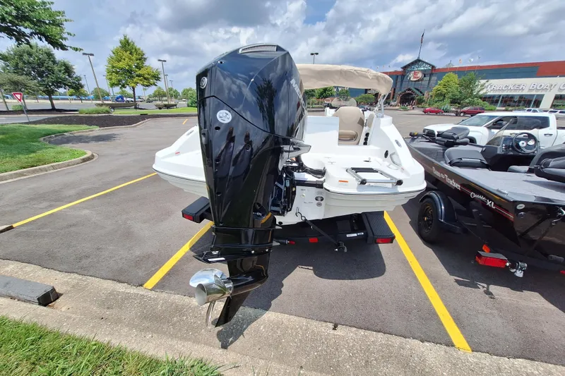 Slide: The Image of 2026 Tahoe 2150 boat with outboard motor in parking lot, sunny day. - 8