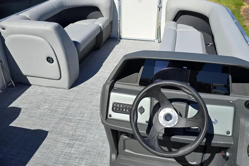 Slide: The Image of Interior of 2026 Sun Tracker Party Barge 18 DLX with steering wheel and seating. - 4