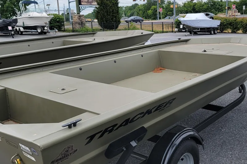 Slide: The Image of 2026 Tracker Grizzly 1754 Utility boat on trailer, parked outdoors. - 3