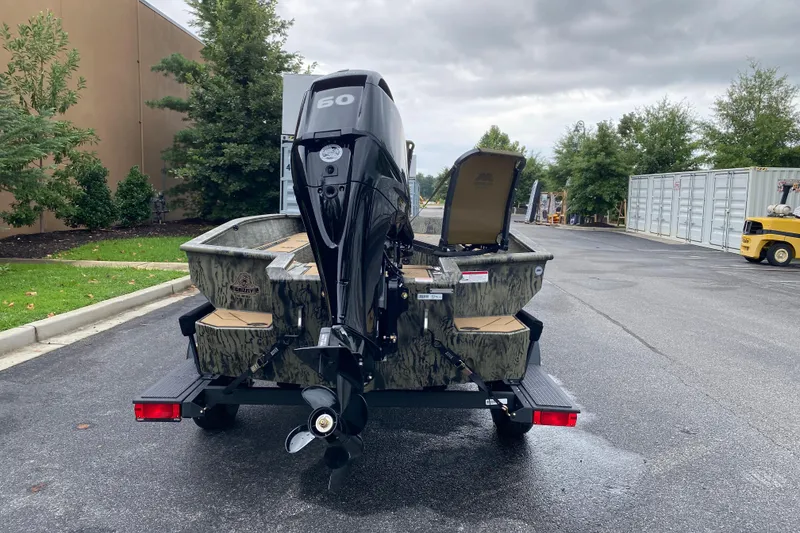 Slide: The Image of 2026 Tracker Grizzly 1756 T Marsh boat on trailer, parked outdoors. - 3