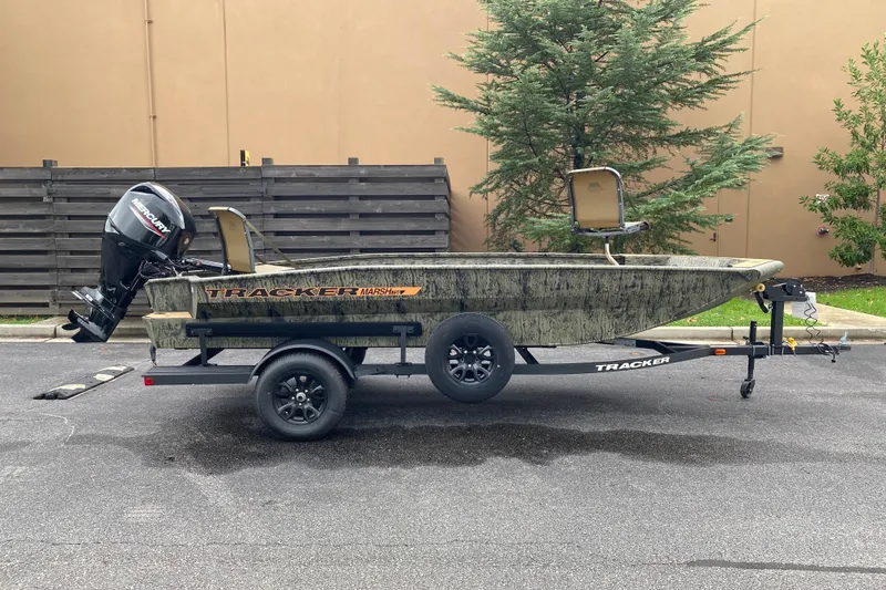 The Image of 2026 Tracker Grizzly 1756 T Marsh boat on trailer, parked outdoors. - 0