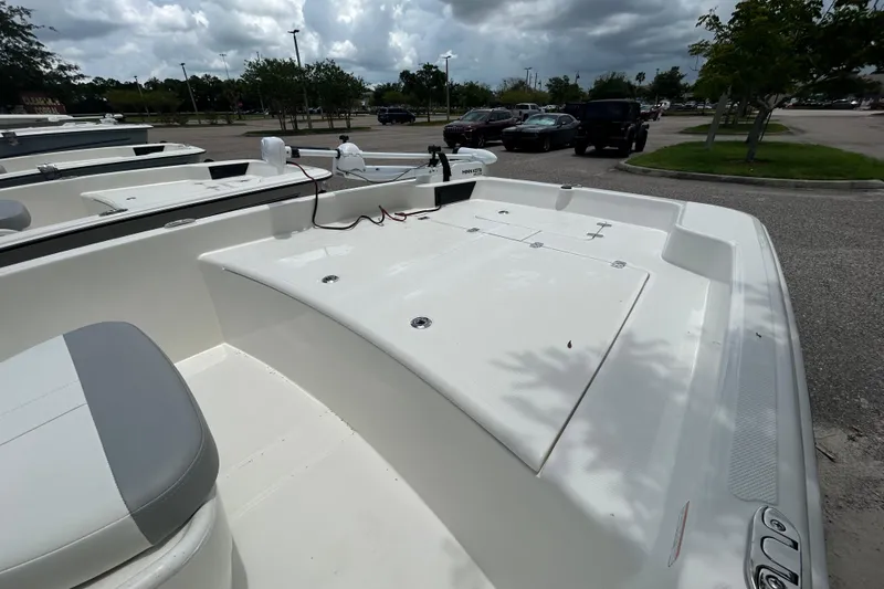 Slide: The Image of 2026 Mako Pro Skiff 17 CC boat in parking lot, showcasing spacious deck and seating. - 4