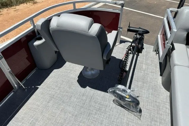 Slide: The Image of 2026 Sun Tracker SportFish 20 DLX pontoon boat interior with seating and trolling motor. - 27