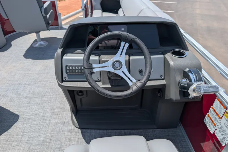 Slide: The Image of Steering console of 2026 Sun Tracker SportFish 20 DLX pontoon boat, featuring modern controls. - 13