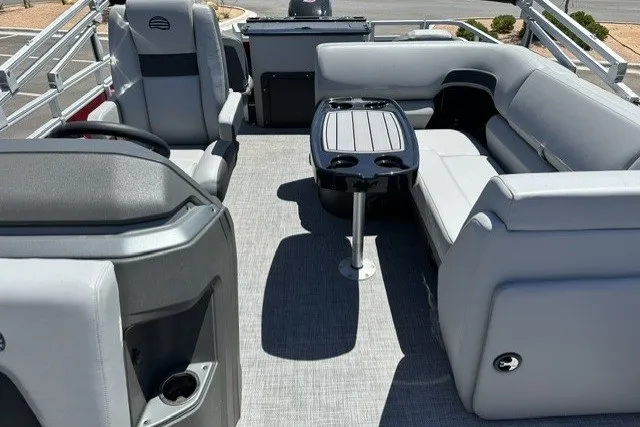 Slide: The Image of 2026 Sun Tracker SportFish 20 DLX pontoon boat interior with seating and table. - 25