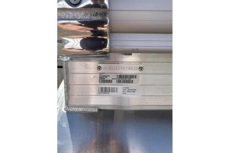 Slide: The Image of 2026 Sun Tracker SportFish 20 DLX identification plate with serial numbers and barcodes. - 114