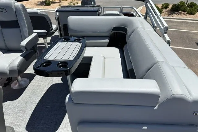 Slide: The Image of 2026 Sun Tracker SportFish 20 DLX pontoon boat interior with gray seating and table. - 18