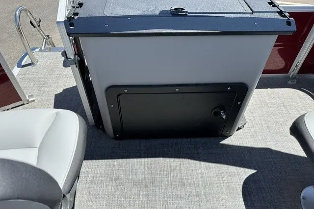 Slide: The Image of 2026 Sun Tracker SportFish 20 DLX boat interior with seating and storage compartment. - 22