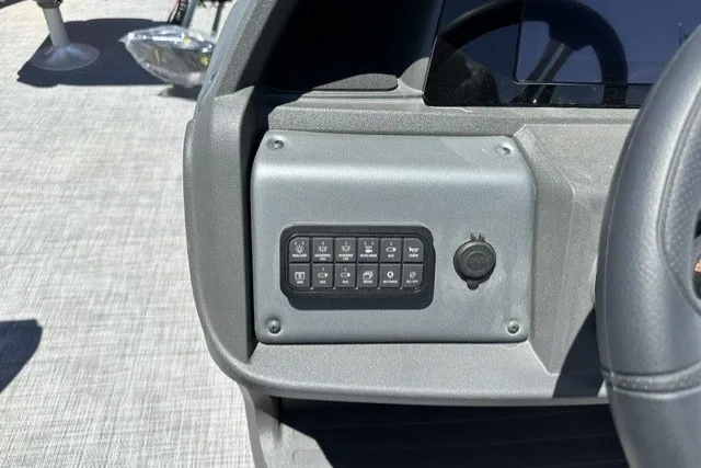 Slide: The Image of Control panel of 2026 Sun Tracker SportFish 20 DLX boat, featuring multiple switches. - 20