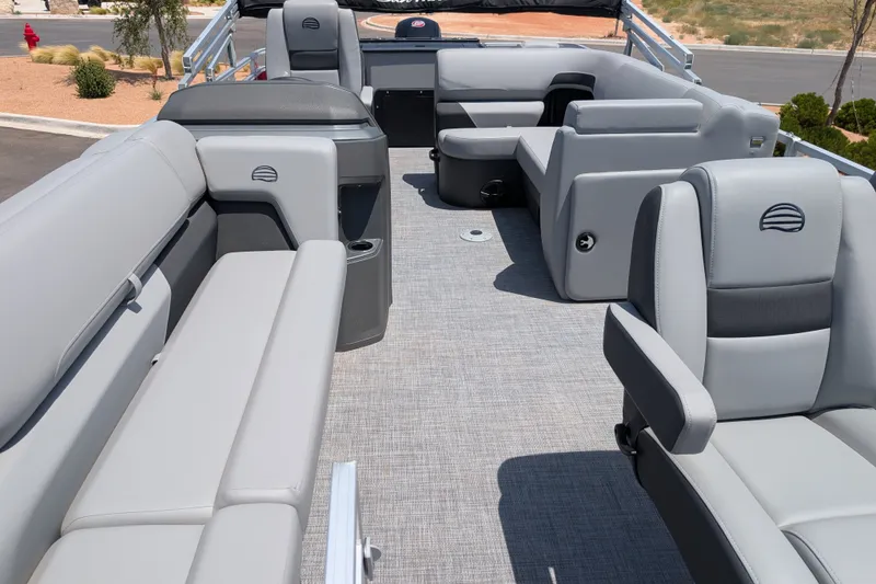 Slide: The Image of 2026 Sun Tracker SportFish 20 DLX pontoon boat interior with gray seating and carpet. - 14