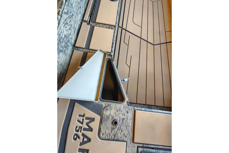 Slide: The Image of 2026 Tracker Grizzly 1756 T Marsh boat interior with open storage compartment. - 10