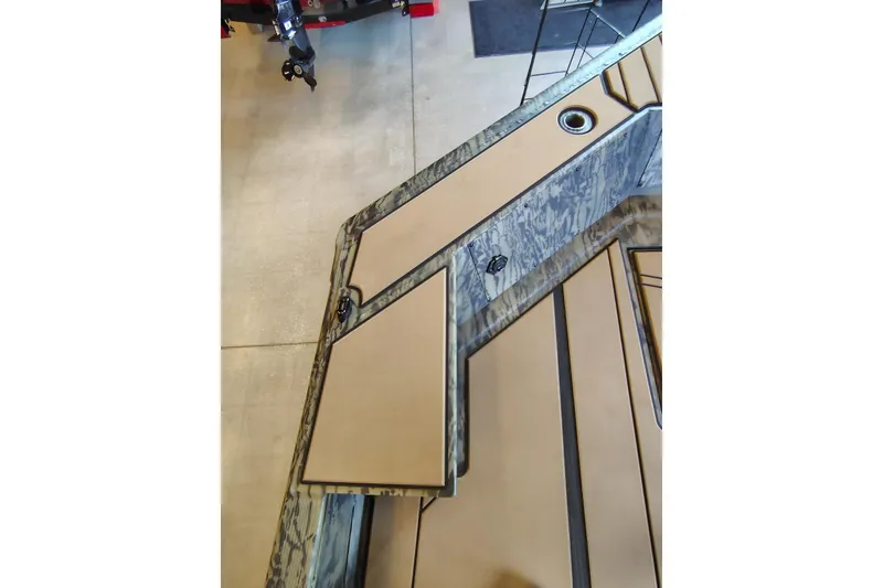Slide: The Image of 2026 Tracker Grizzly 1756 T Marsh boat interior with camo design and storage compartments. - 8