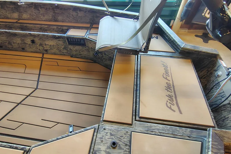 Slide: The Image of 2026 Tracker Grizzly 1756 T Marsh boat interior with camo design and seating. - 6