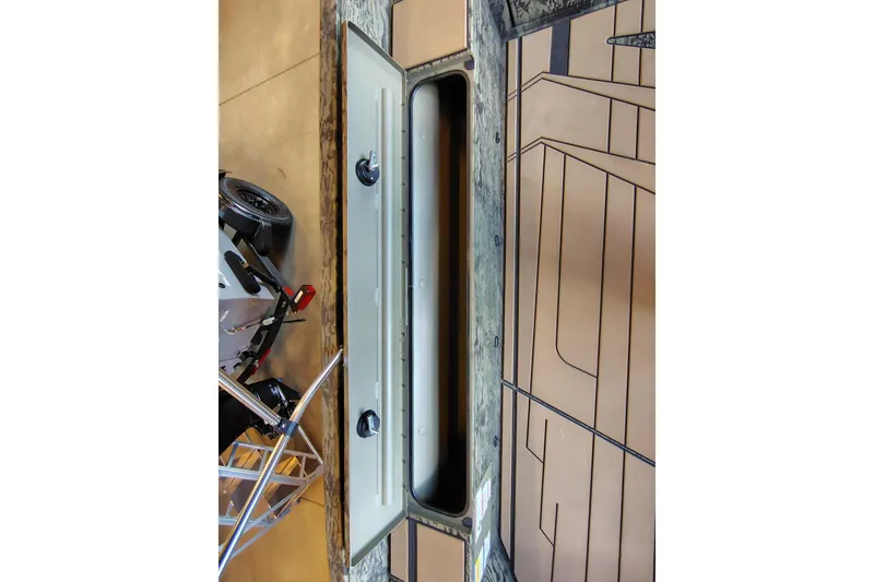Slide: The Image of Open storage compartment on 2026 Tracker Grizzly 1756 T Marsh boat. - 5