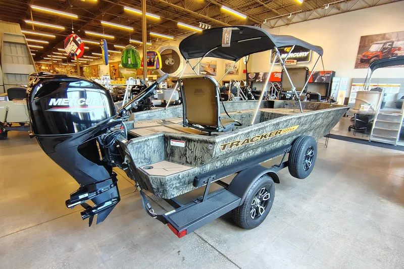 Slide: The Image of 2026 Tracker Grizzly 1756 T Marsh boat with Mercury engine in showroom. - 2